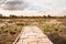 Panorama view Bamboo Bridge over The red Lotus Lake against blue sky in Summer Tung Dok Bua Dang .Nakorn Pratum Thailand