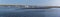 A panorama view of boats moored in Brancaster Bay near Burnham, Norfolk, UK