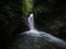 Panorama view of Cascada Colibries waterfall in tropical rain cloud forest Mindo valley jungle Nambillo Ecuador andes