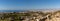 Panorama view of the coastline at Almerimar with hotels and golf courses and beaches and trash in the foreground