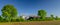 Panorama view of countryside in North Germany with biogas plant. Cornfield with agricultural factory in the background in the coun