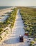 Panorama view, extreme couple travelers on car at country beach road among sea, sand, nature. Summer adventure, drone