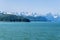 A panorama view of the forested islets and mountain backdrop of the Gastineau Channel on the approach to Juneau, Alaska