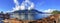 Panorama view from Furry Creek, BC, Canada, with dramatic cloudscape and driftwood on beach in winter time