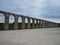 Panorama view of historic old roman watercourse aqueduct gate archway bridge building in Obidos Portugal Europe