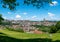 Panorama view of the historic Swiss city of Fribourg with its old town and many bridges and cathedral framed by green leaves