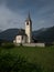 Panorama view of idyllic white alpine mountain chapel church in San Vito di Braies Prags Puster Valley South Tyrol Italy