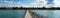 Panorama view of the long pier at Altnau harbor on Lake Constance with many boats and people
