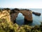 Panorama view of natural limestone arch bridge Arco de Albandeira beach atlantic ocean cove bay in Algarve Portugal