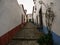 Panorama view of old historic white walls houses buildings narrow cobblestone lane alley street in Obidos Portugal