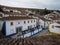 Panorama view of old historic white walls houses buildings narrow cobblestone lane alley street in Obidos Portugal