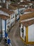 Panorama view of old historic white walls houses buildings narrow cobblestone lane alley street in Obidos Portugal