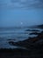 Panorama view of orange supermoon over atlantic coast at Praia dos Rias beach in Malpica Galicia Spain during blue hour