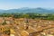 A panorama view over the roof tops toward some of the many towers in Lucca, Italy