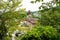 Panorama view over the roofs and pagodas framed by trees, Miyajima, Japan