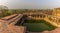 A panorama view over a well at the abandoned temple at Fathepur Sikri, India at sunset