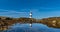 Panorama view of the Penmon Lighthouse in North Wales with relfections in a tidal pool