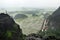 Panorama view of rice fields, rocks and mountaintop pagoda