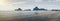 Panorama view of sea beach and traditional boat laying on the beach, mountain on background, light effect added, blue filtered