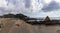 Panorama view of a secluded sandy beach on a wild mountainous coastline with rocks