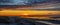 Panorama view of splendid sunset at the Wadden sea of Sankt Peter Ording with stilt houses on the background, North Sea, North Fri