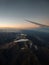 Panorama view of sunset in snowcapped andes mountains with aeroplane wing from airplane window seat in Santiago de Chile