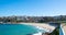 Panorama view of Sydney Bondi Beach NSW Australia. White Sandy Beach, turquoise blue water and surfing waves