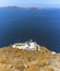 A panorama view of a traditional greek church below Skaros Rock