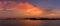 A panorama view of the vibrant stage of the sunset over the island of Bali, Asia