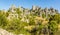 A panorama view of the weathered limestone rock stacks and cliff face in the Karst landscape of El Torcal near to Antequera, Spain