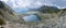 Panorama of Vysne Wahlenbergovo lake in Slovakia High Tatras mountains with fluffy gray clouds. Hiking, trekking, tourism.