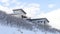 Panorama Wasatch Mountain setting with a house on the pristine snowy slope in winter