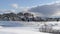 Panorama Wasatch Mountain in winter with houses on sunlit acres of snow covered terrain