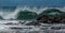 Panorama wave cresting behind rock in Hawaii