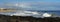 Panorama of waves splashing on basalt rocks at Ocean Beach Bunbury Western Australia