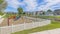 Panorama Whispy white clouds Small playground with white picket fence in community at Utah