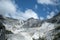 Panorama of a white Carrara marble quarry in Tuscany. Mountains of the Apuan Alps, blue sky