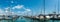 Panorama of a white motorboat preparing to enter a berth in Konstanz harbor and docking