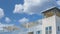 Panorama White puffy clouds Residential building exterior with pergola roofs at the rooftop