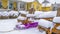 Panorama Winter in Daybreak with view of a purple sled in the middle of wooden chairs