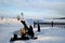 Panorama of the winter embankment of the Volga River with a view of the large anchor on the shore and the lighthouse.