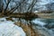 Panorama of the winter landscape, frozen river, riverbed. it`s snowing on the beach
