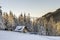 Panorama of winter mountains with houses of shepherds. Carpathians, Ukraine, Europe. Fantastic winter landscape. Creative