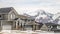 Panorama Winter neighborhood with homes viewed against snowy mountain and cloudy sky