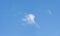 Panorama of wispy cloud in blue sky.