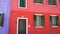 Panorama of wonderful red and purple doll-like houses in Burano, Venice