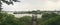 Panorama. The wooden pier overgrown with reeds on the lake of Sokcho city. South Korea