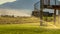 Panorama Yard water sprinkler and stairs of the balcony viewed against lake and mountain