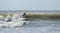 Panorama of young boy surfing on the Atlantic Ocean
