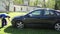 Panorama of young man clean wash black favorite car with foam